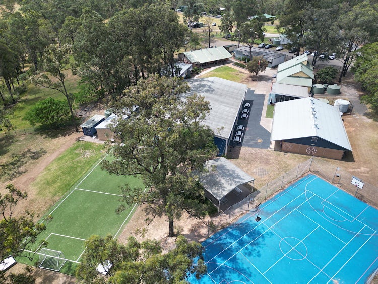Aerial shot of the school premises showing soccer field and basketball/tennis court