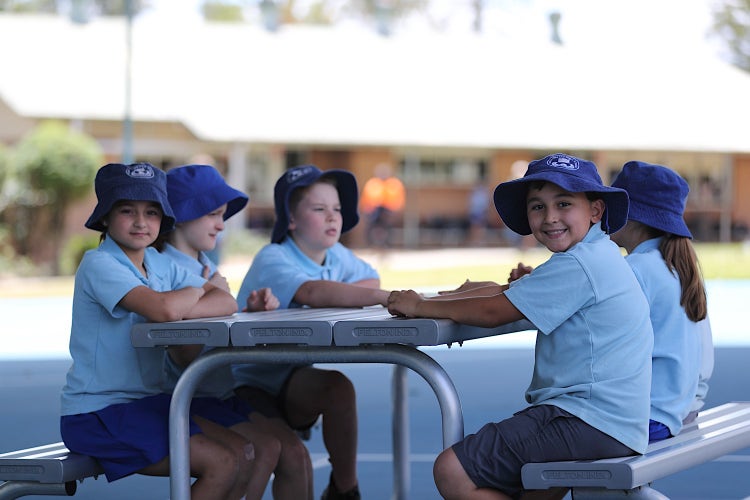 Image of students sitting around a table outside
