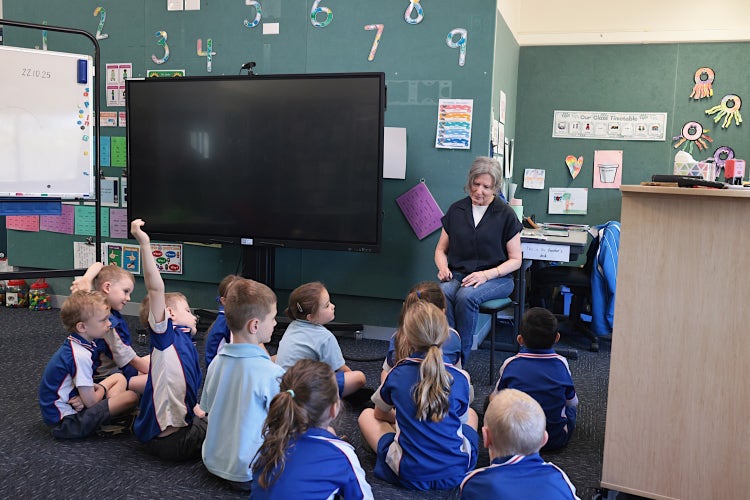 Photo of students in a classroom with their teacher