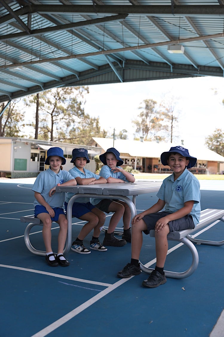 Students sitting around a table in the playground