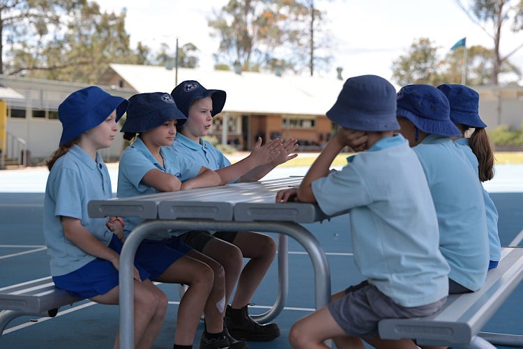 Photo of school students sitting around a table